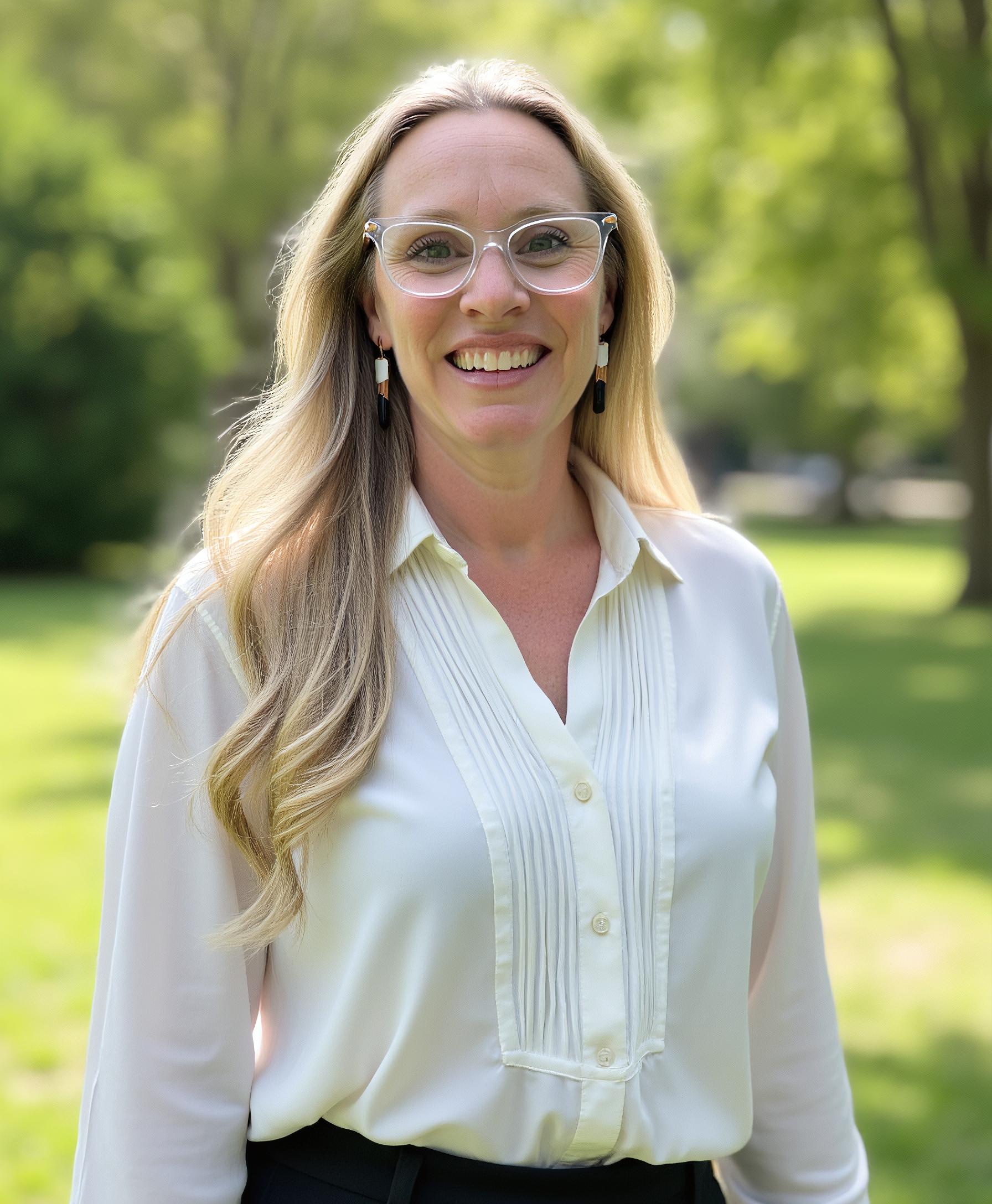 white female with glasses smiling