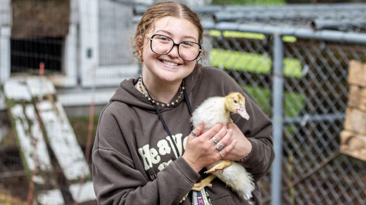 White female holding a duck