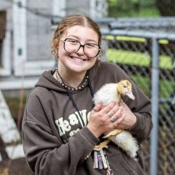 young adult female holding a duckling