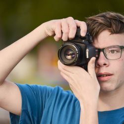 young adult male taking a picture