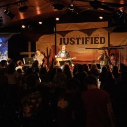 inside of camp chapel with a band on stage in front of a room full of students