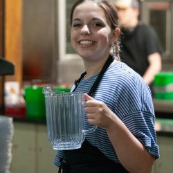 young lady holding a water pitcher