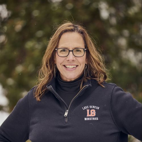 white female with glasses smiling