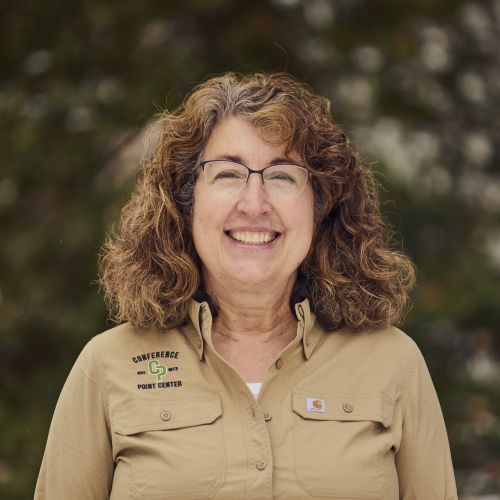 white female with glasses smiling