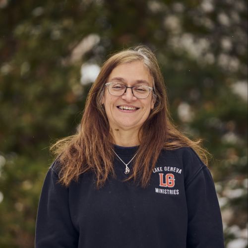 white female with glasses smiling