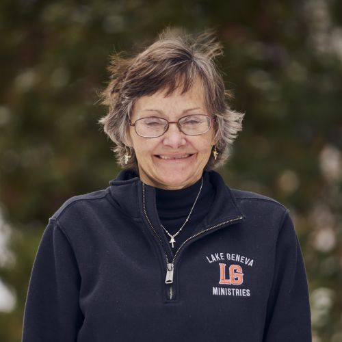 white female with glasses smiling