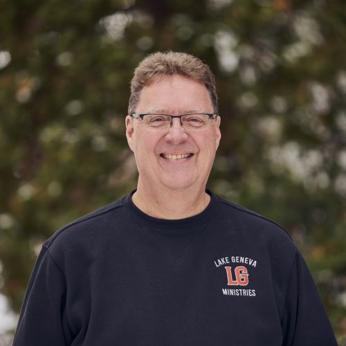 white male with glasses smiling