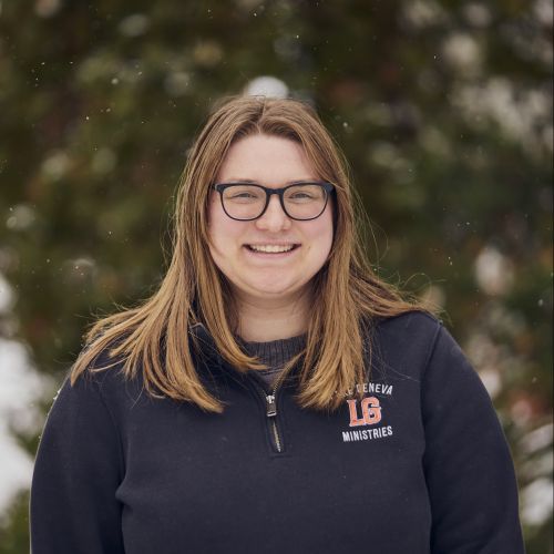 white female with glasses smiling