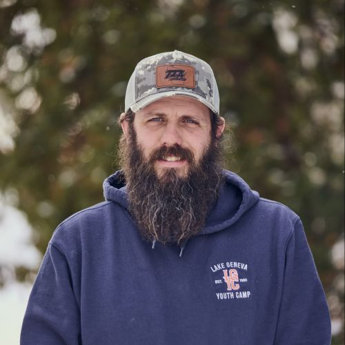 white male with hat smiling