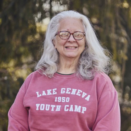 white female with glasses smiling