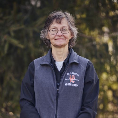 white female with glasses smiling