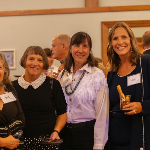four women at the spark gala smiling at camera
