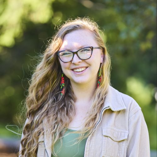 white female with glasses smiling